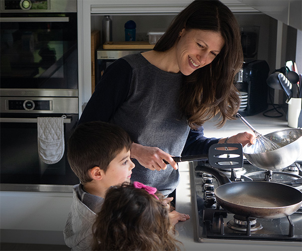 Mum cooking with kids in kitchen