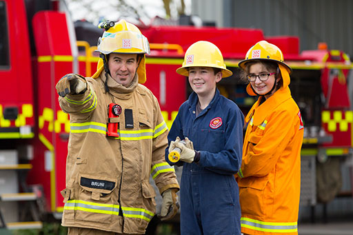 Senior firefighter instructing junior firefighters