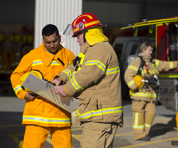 Firefighters talking on front of station