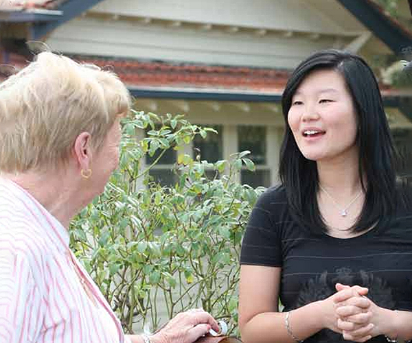 Young lady talking to elderly