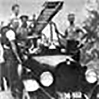 black and white image of old fire truck and firefighters