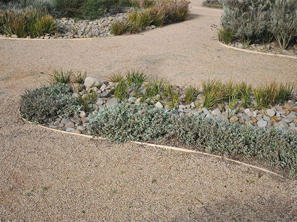Gravel paths run between garden beds.