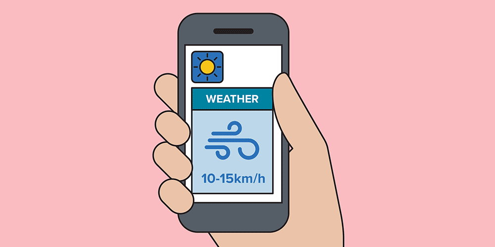 Illustration of a hand holding a smartphone displaying a weather app with sun and wind icons, showing wind speed of 10-15 km/h.