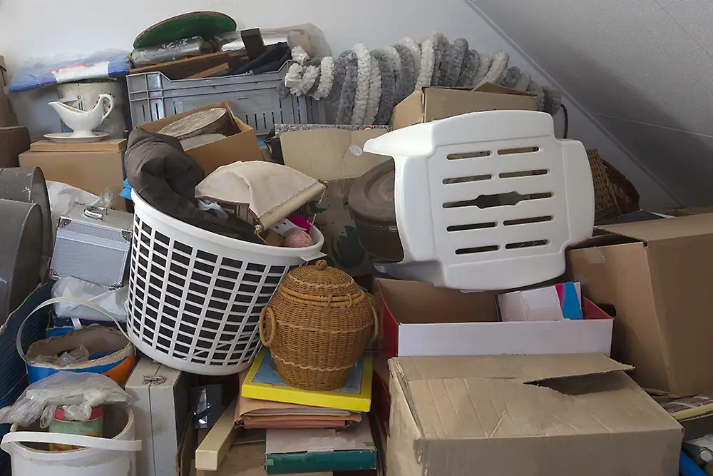 Cluttered possessions including boxes, buckets and baskets of assorted items all stacked one on top of the other.