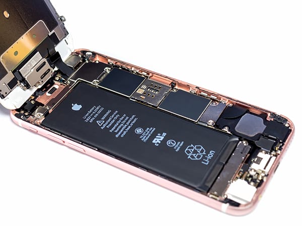 A smartphone with the back open showing a battery in good condition which is flat and clean