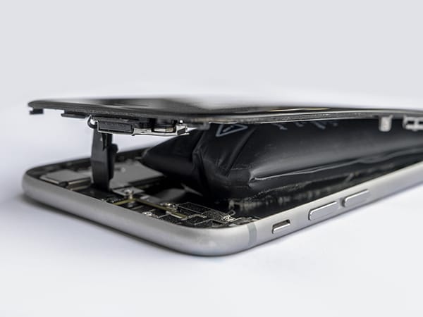 A smartphone with swollen Lithium-ion battery which has pushed the back off the phone
