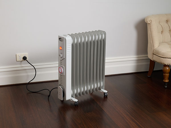 Electric heater plugged into a wall power point.