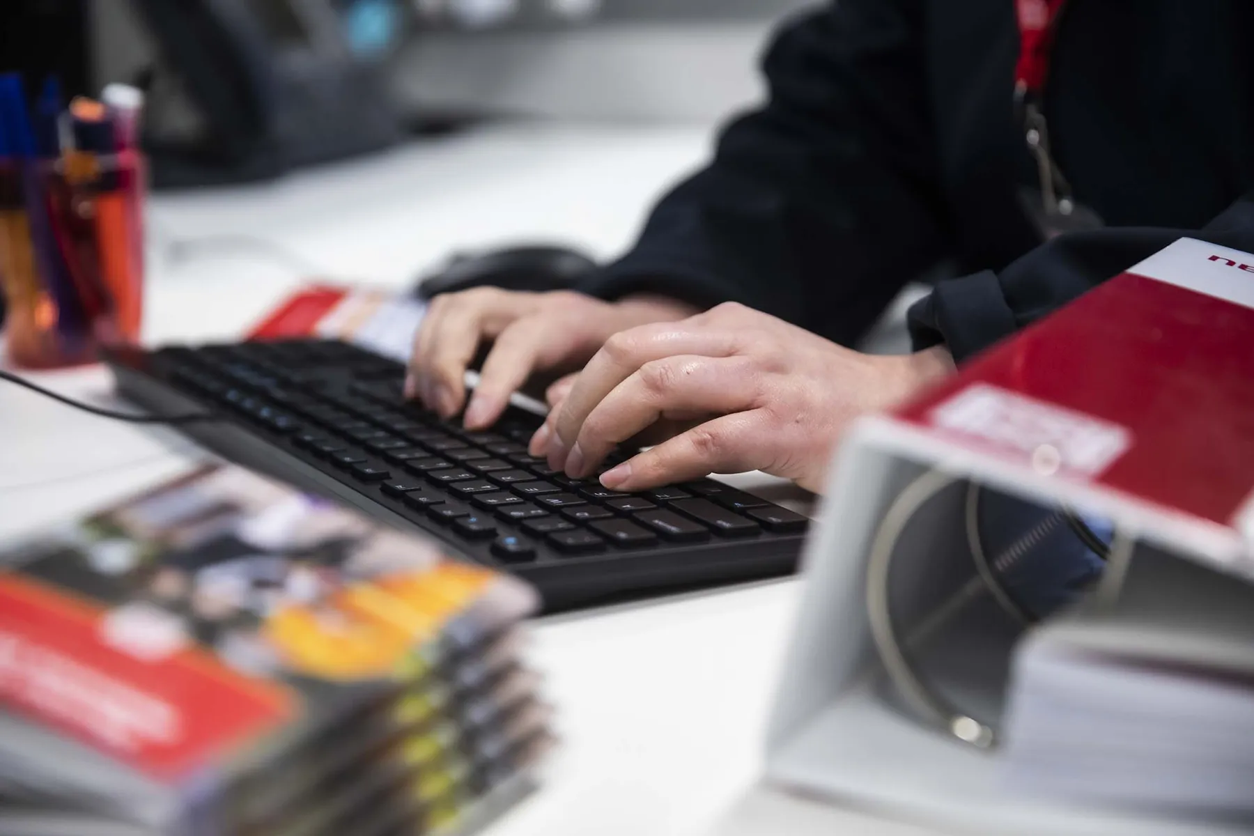 Person working at the office using a computer keyboard