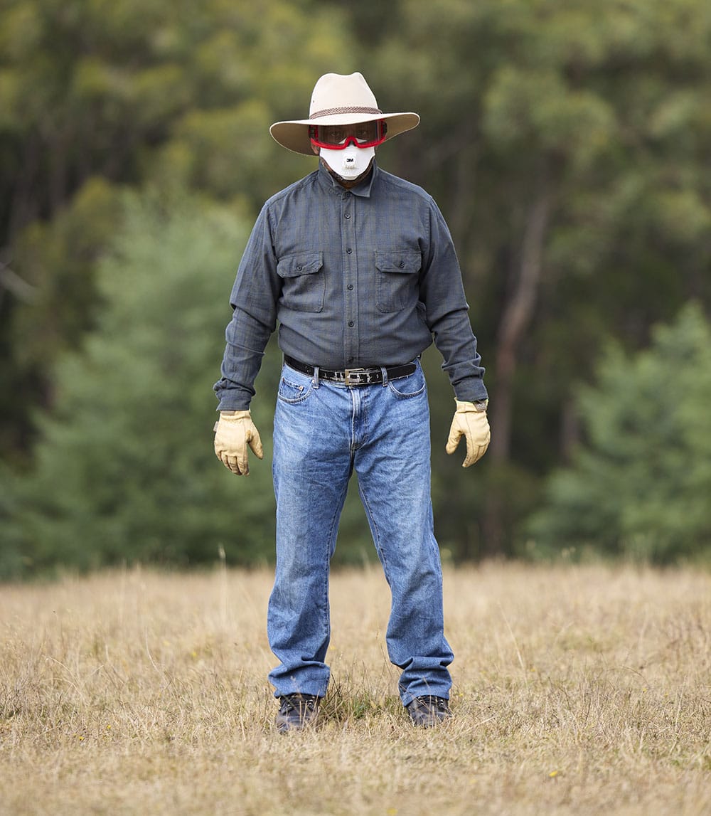 An interactive image of a man standing in a field wearing protective clothing. Red hot spots over different items of clothing provide further information about the image.