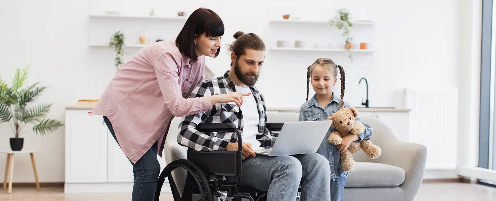 Woman man in wheelchair and child indoors