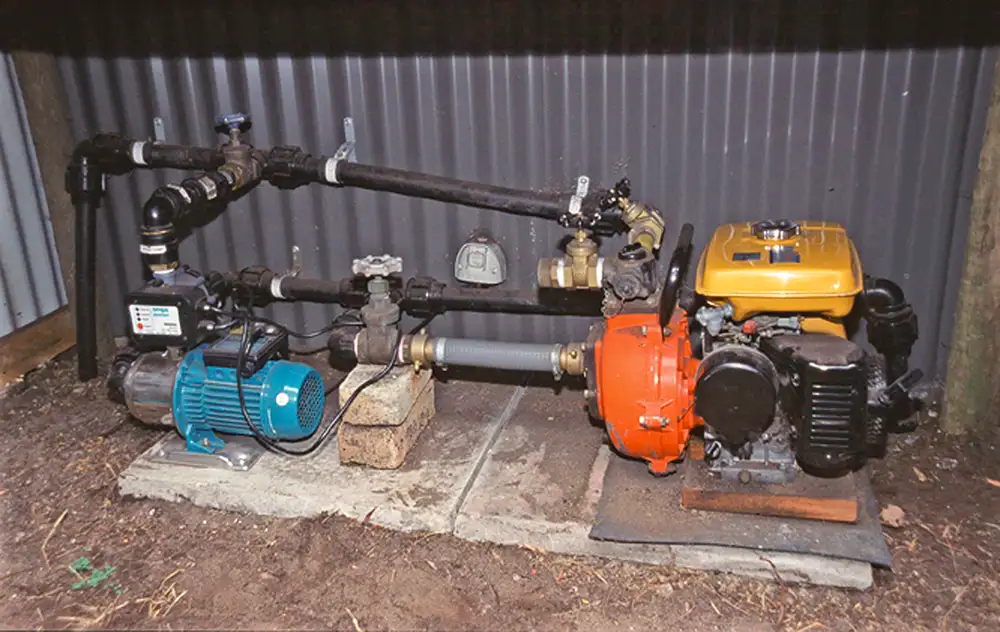 A complex system of pipes connecting both domestic water supply, via an electric on-demand pump alongside a petrol powered pump to provide water for bushfire firefighting.