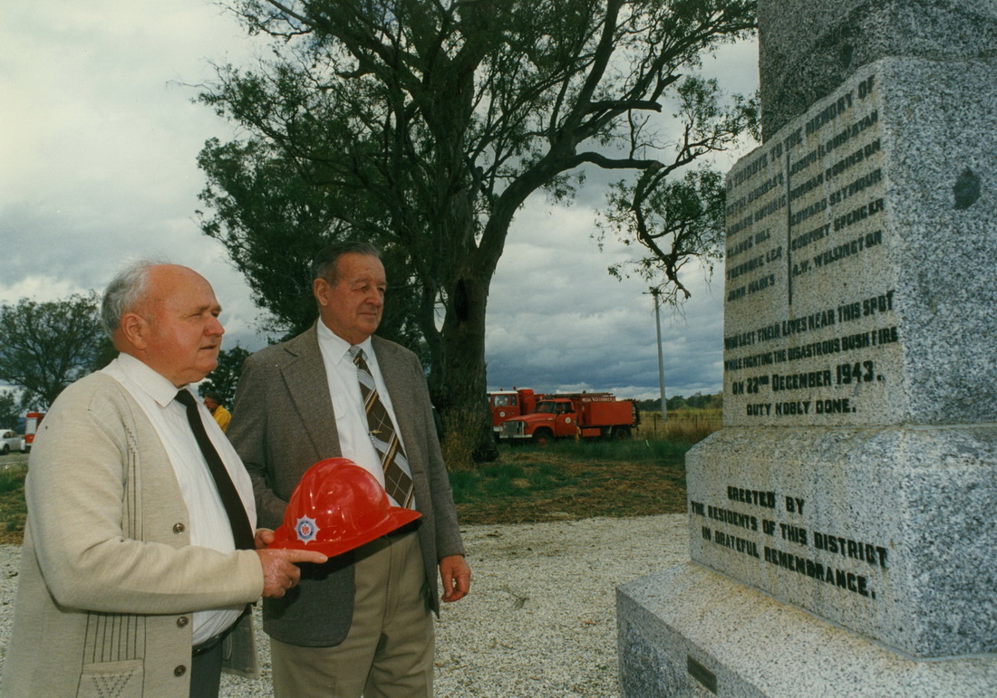 Two men looking at memorial stone at Tarrawingee past memorial